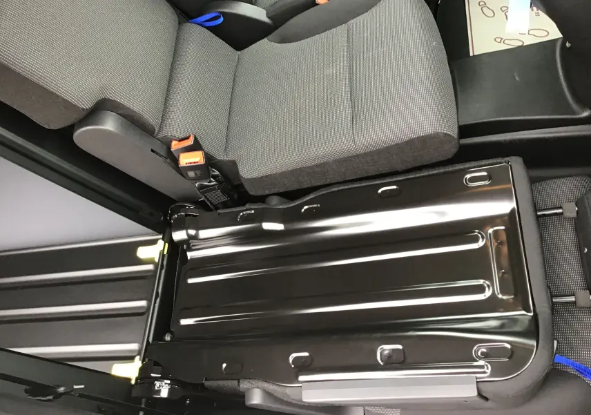 Vue rapprochée du siège arrière droit du Peugeot Partner XL blanc, montrant le plancher antidérapant sous l'assise relevée.