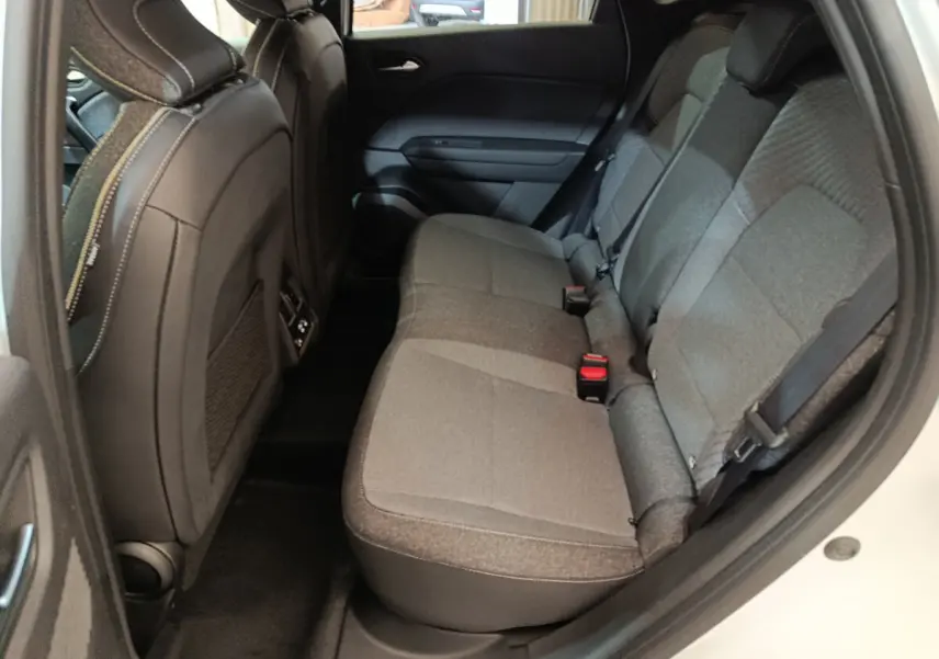 Vue intérieure côté droit montrant la banquette arrière grise du Renault Captur blanc techno E-Tech 2025.