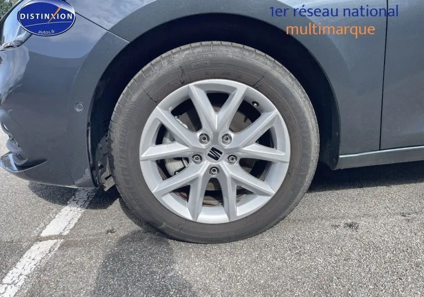 Gros plan sur la roue avant gauche d'une SEAT LEON gris magnétique métal avec jante alliage 16 pouces.