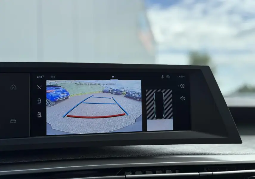 Écran central du Peugeot 5008 Hybrid blanc montrant la caméra de recul avec lignes de guidage et vue périphérique.