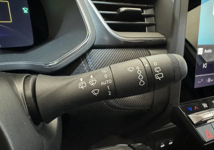 Gros plan sur la commande d’essuie-glace dans l’habitacle noir du Renault Captur blanc esprit Alpine E-Tech 2025.
