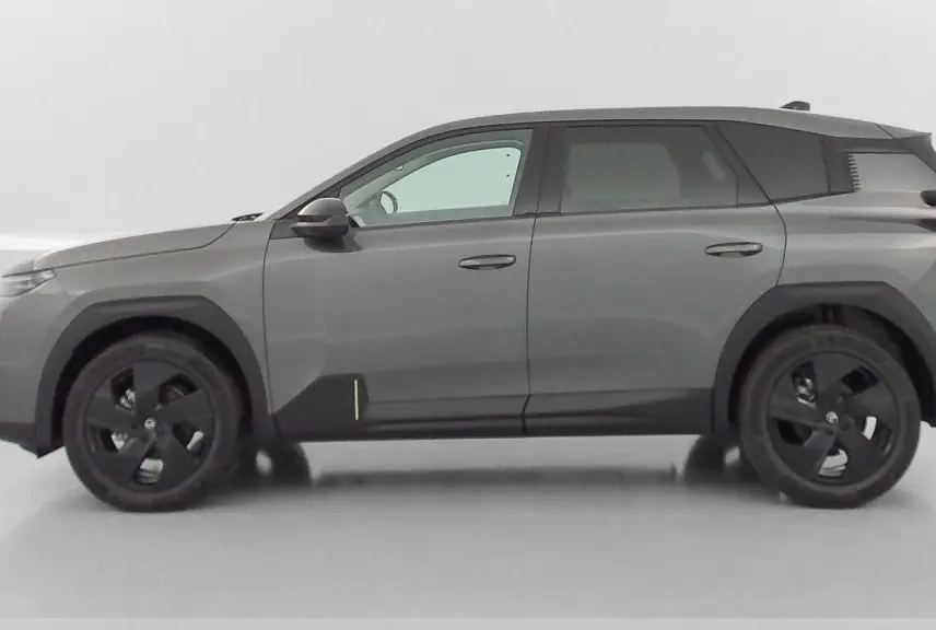 Vue de profil côté gauche d'un Citroën C5 Aircross hybride gris platinium avec jantes noires et détails noirs contrastants.