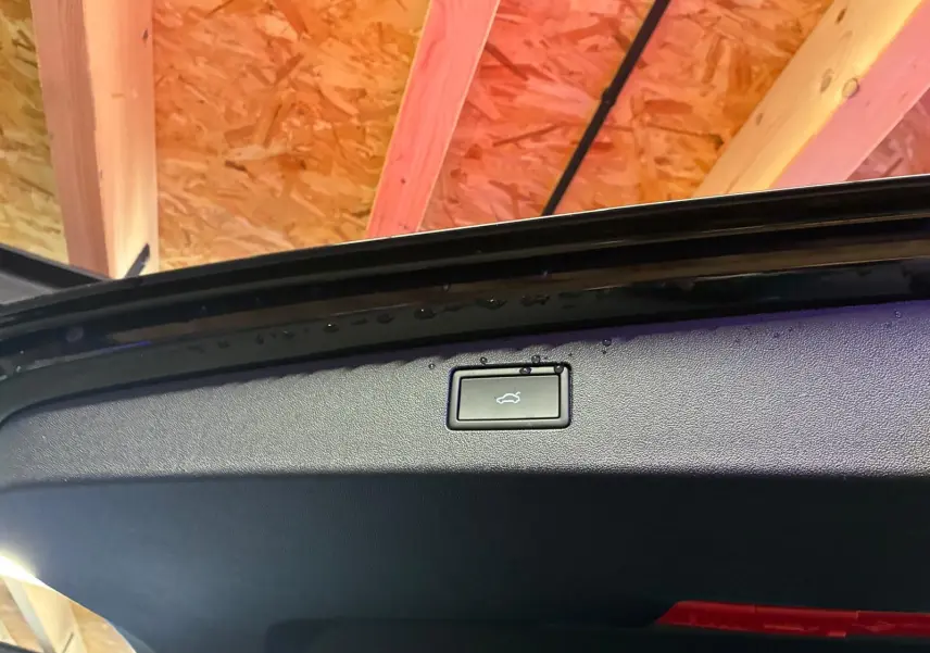 Bouton d'ouverture électrique du coffre sur le hayon noir grenadilla métal d'un Volkswagen Tiguan 2026.