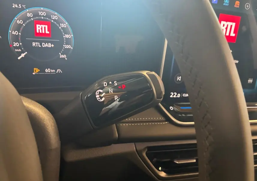 Gros plan sur le levier de boîte automatique noir dans l’habitacle du Volkswagen Tiguan 2026, avec tableau de bord digital affichant RTL.