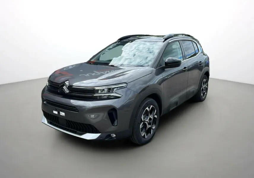 Citroën C5 Aircross Hybrid 2025 gris platinium avec toit noir, vue 3/4 avant droit soulignant ses jantes distinctives.