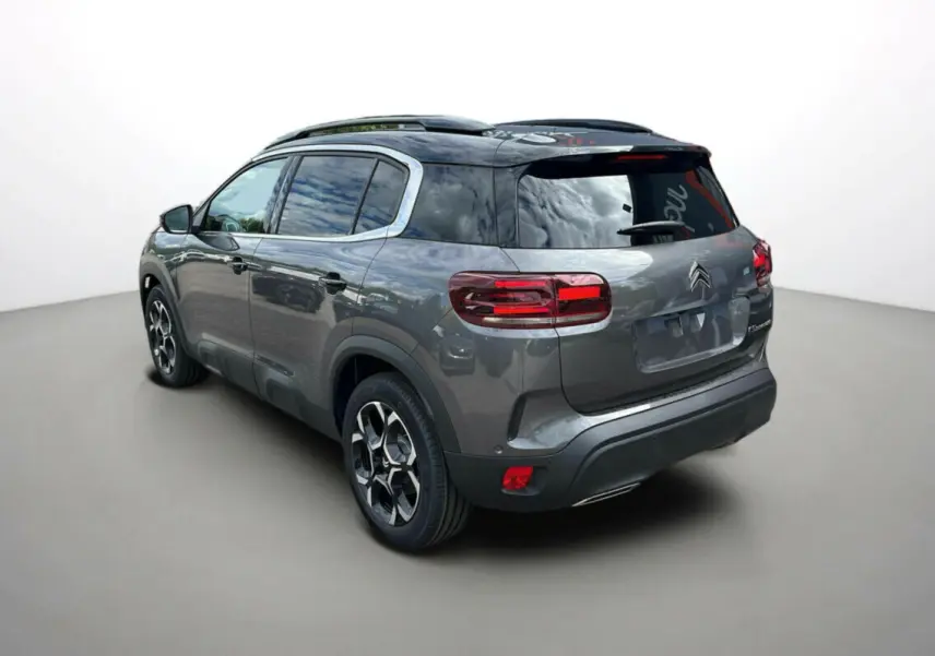 Citroën C5 Aircross Hybrid 2025 gris platinium avec toit noir, vue 3/4 arrière côté gauche, jantes distinctives.