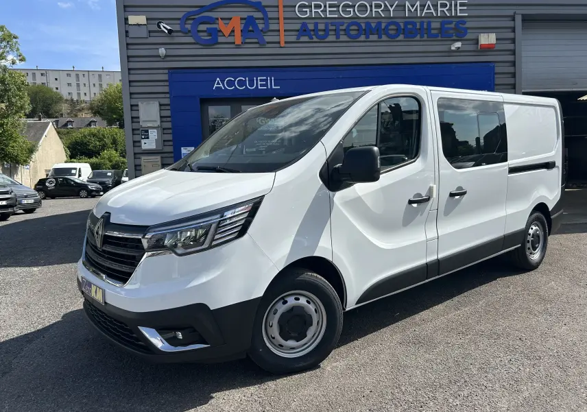 Vue 3/4 avant droit d’un Renault Trafic cabine approfondie blanc, avec portes latérales coulissantes et jantes acier.
