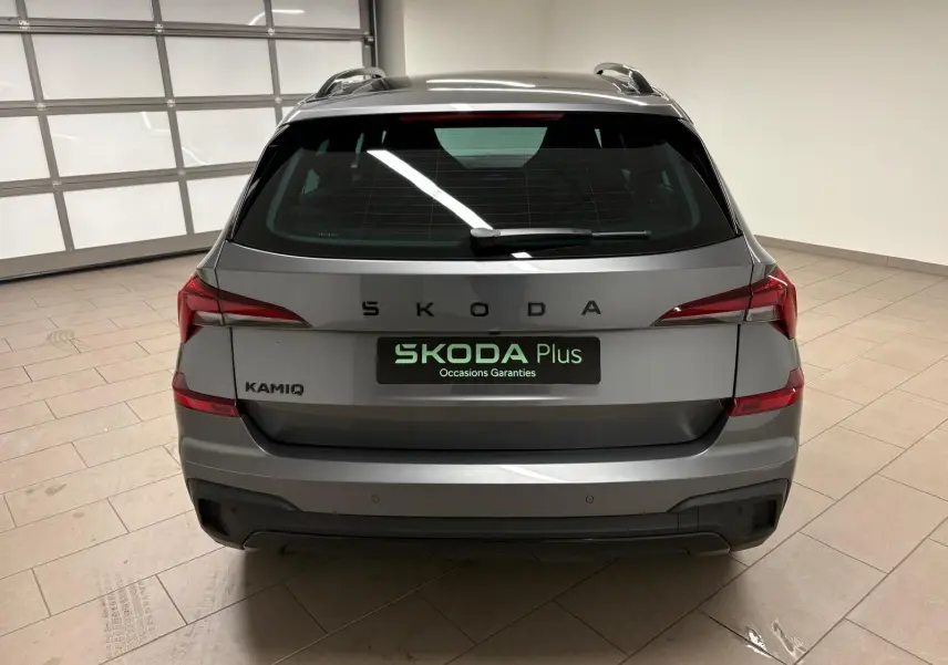 Vue arrière d'un Skoda Kamiq 2024 gris graphite, avec logo SKODA et feux arrière LED distinctifs en intérieur.