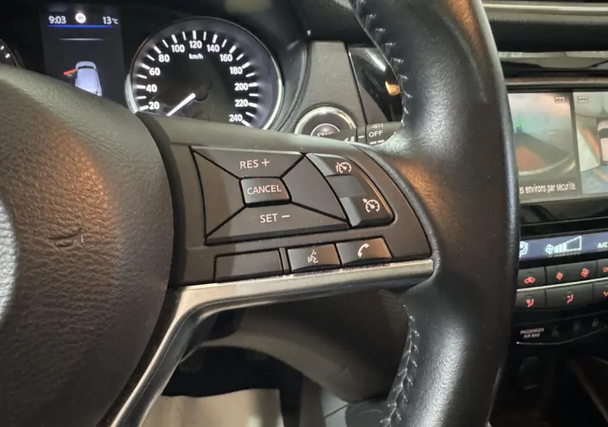 Gros plan sur le volant cuir alu du Nissan Qashqai 2019 avec commandes multifonctions et tableau de bord partiel visible.