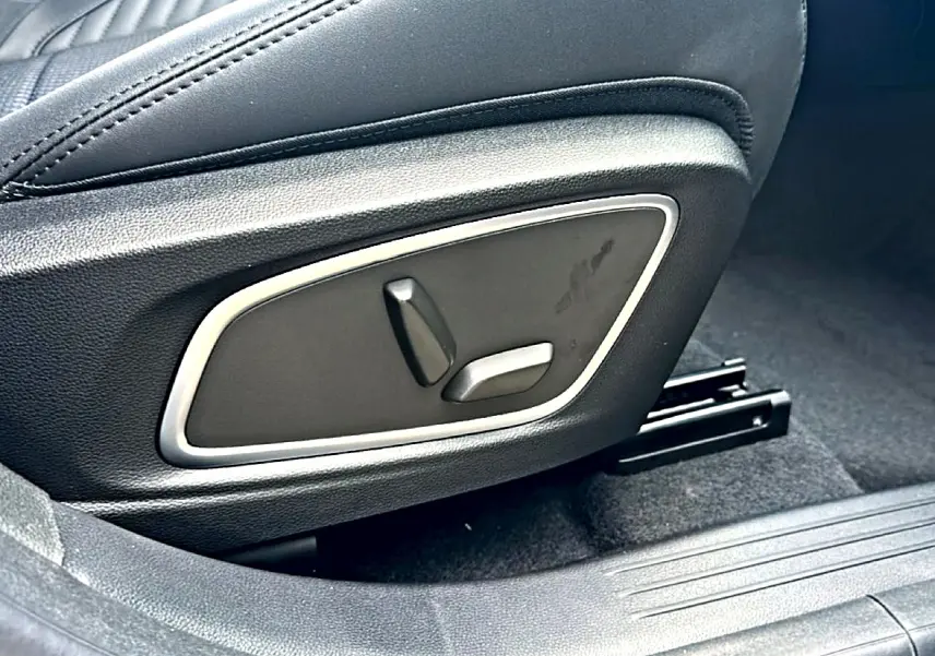 Gros plan sur les commandes électriques du siège avant noir du Renault Austral 1.2 e-tech hybride.