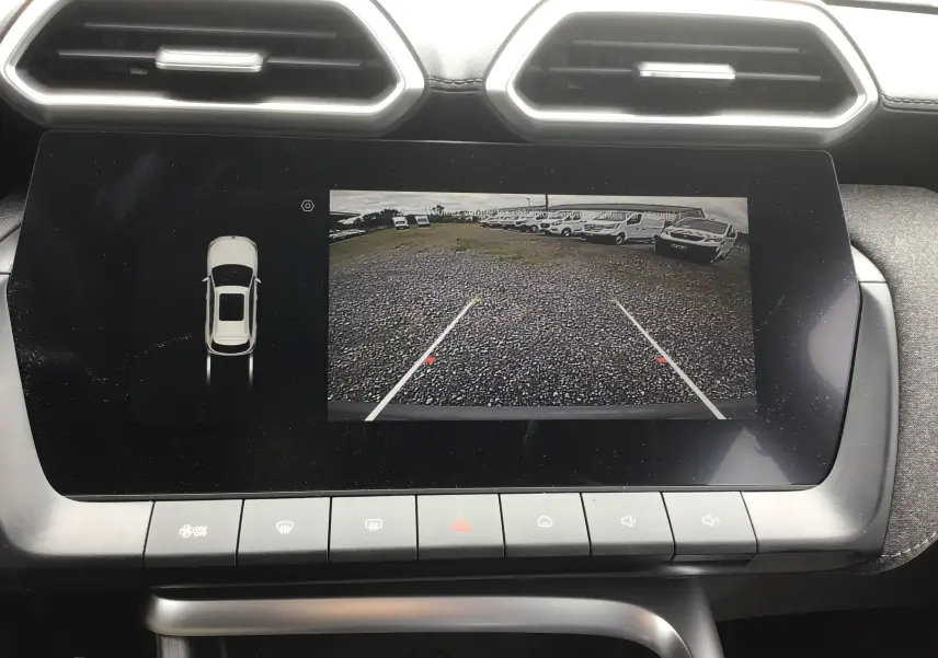 Écran tactile intérieur montrant la caméra de recul et l'affichage du véhicule en vue de dessus du MG ZS Cosmic Silver.