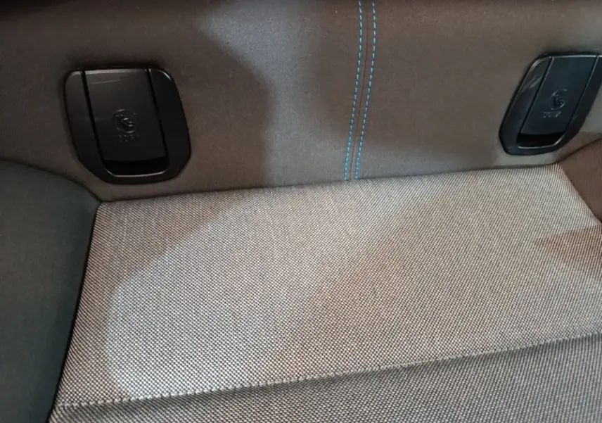 Gros plan sur la banquette arrière grise avec coutures bleues et attaches Isofix d'une BMW i3 noire 2020.