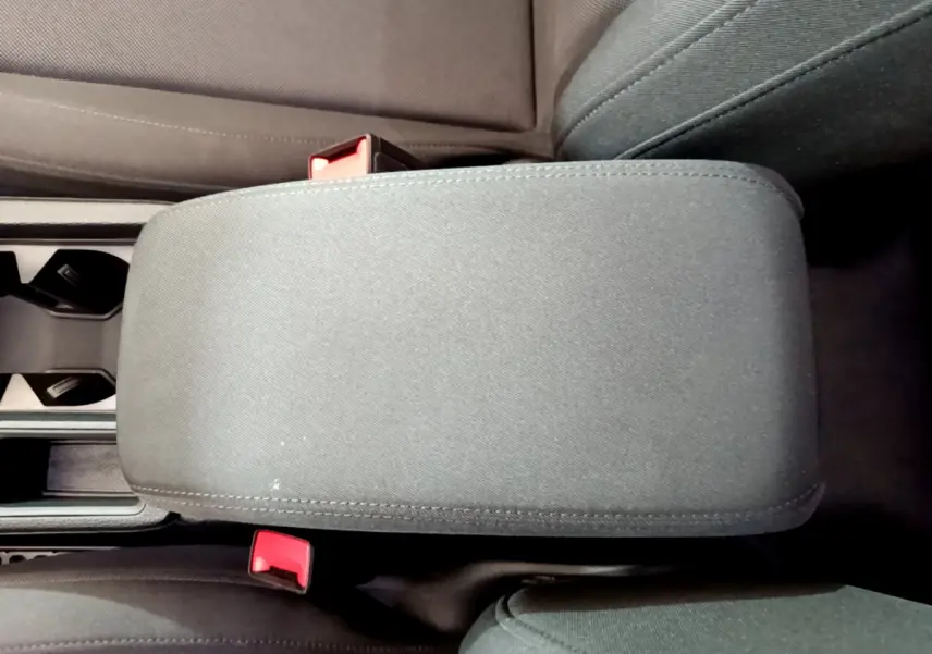 Vue plongeante sur l'accoudoir central noir et les sièges avant du coffre Audi Q3 35 TDI 2021.