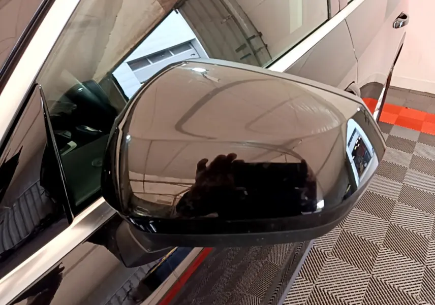 Rétroviseur noir côté gauche d’un Audi Q3 35 TDI 2021 avec caméra intégrée et carrosserie brillante