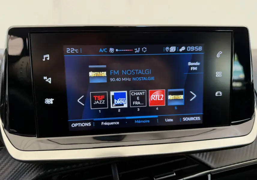 Écran tactile central de la Peugeot 208 2021 affichant les stations radio FM avec interface moderne et boutons tactiles.