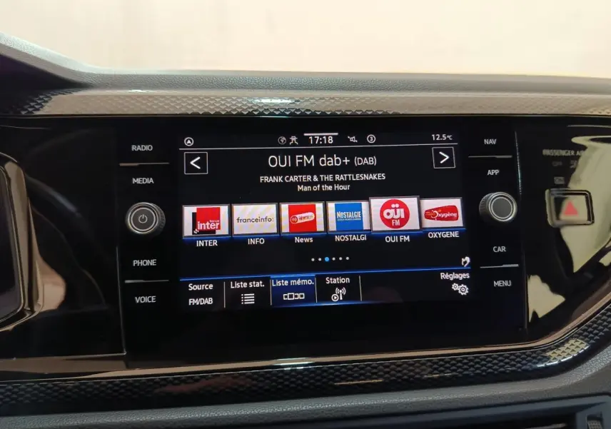 Écran tactile central du Volkswagen Taigo 2023 affichant la radio DAB+ avec commandes physiques autour, vue de face.