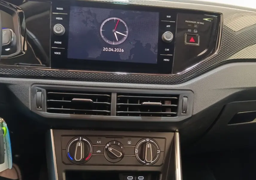 Vue rapprochée du tableau de bord du Volkswagen Taigo 2023, écran tactile central affichant une horloge digitale.