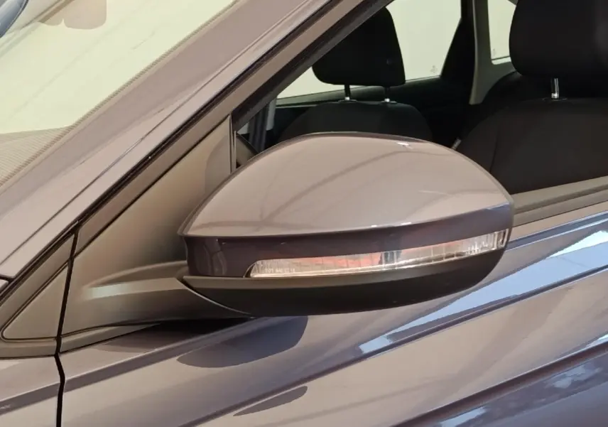 Rétroviseur côté gauche gris foncé du Volkswagen Taigo 1.0 TSI 110 DSG Life Plus 2023 avec clignotant intégré.