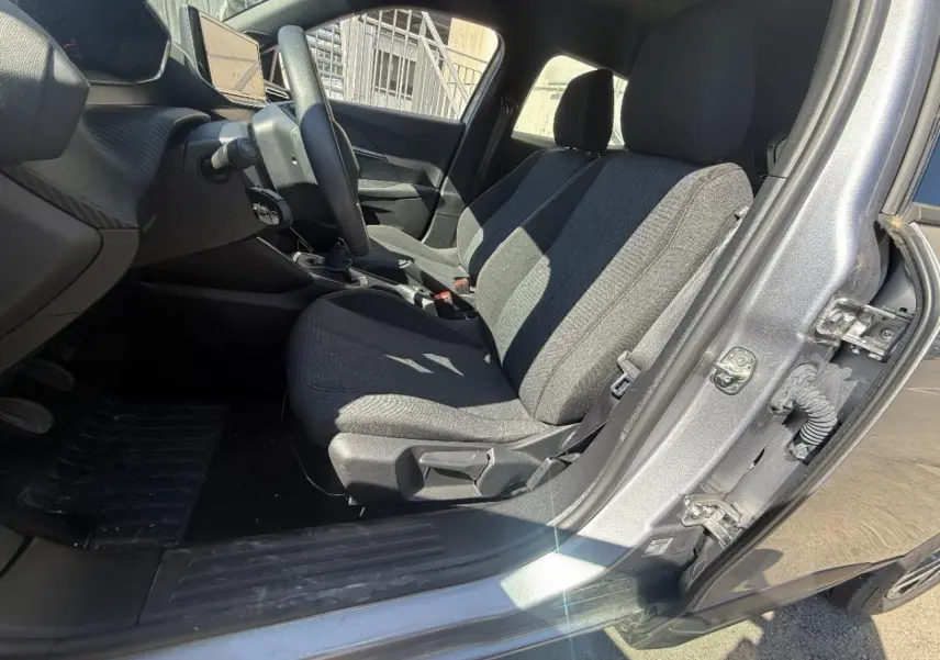 Intérieur côté conducteur du Peugeot 2008 2025 artense, montrant les sièges tissu gris et la boîte manuelle.