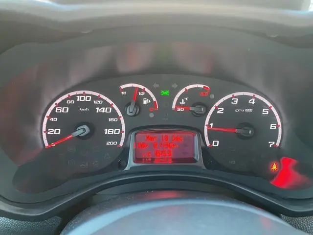 Vue rapprochée du tableau de bord du Ford Ka blanc 2015, affichant la vitesse, le compte-tours et les indicateurs lumineux.