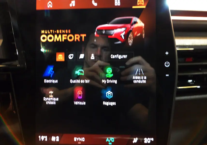 Écran tactile affichant une Renault Rafale rouge flamme en 3/4 avant avec toit noir dans le menu confort.
