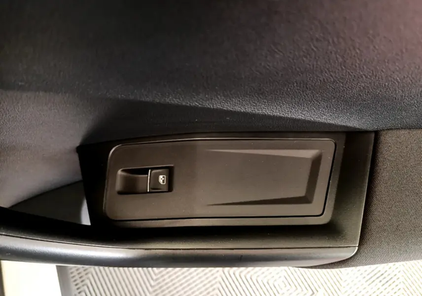 Gros plan sur le bouton de verrouillage centralisé côté intérieur d'une Volkswagen T-Roc blanc, version 2020.