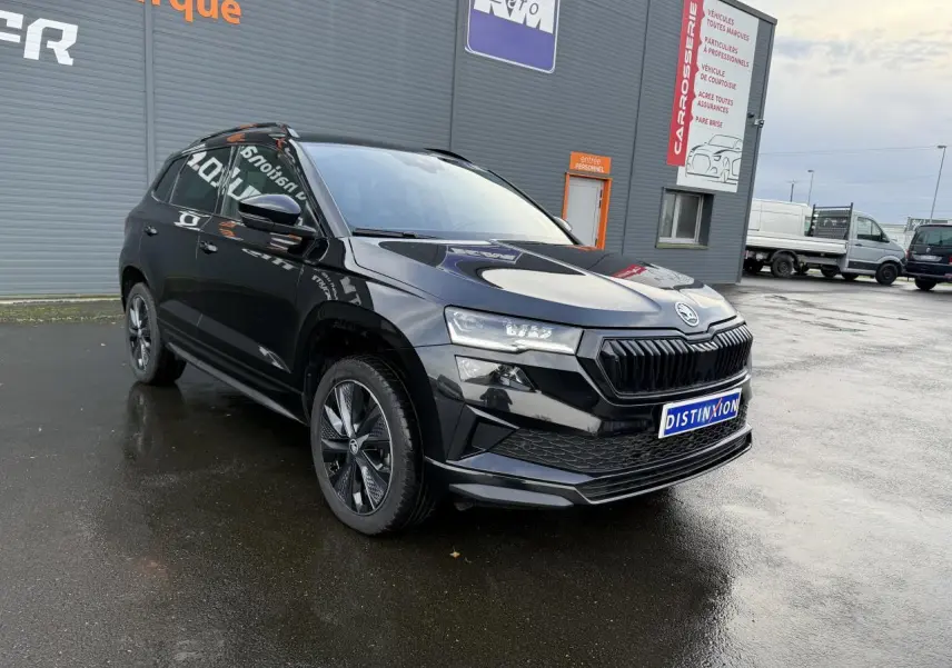 Vue 3/4 avant gauche d'un Skoda Karoq noir Magic nacré avec jantes alliage noires et phares Full LED Matrix.