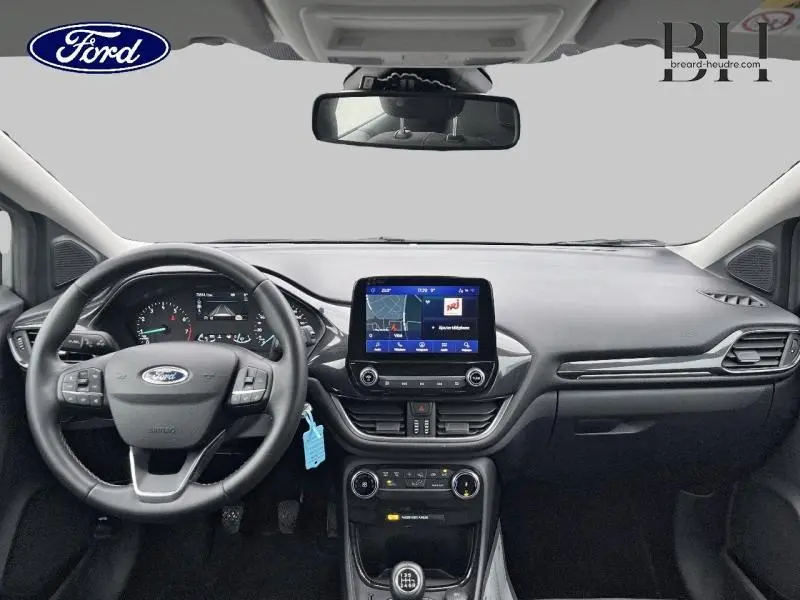 Vue frontale de l’habitacle du Ford Puma 2023, tableau de bord noir avec écran tactile central et volant multifonction.