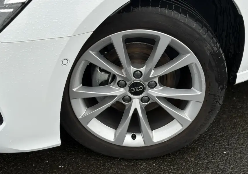 Gros plan sur la jante alliage 17 pouces argentée de l'Audi A3 Berline blanc Arkona, côté avant droit.