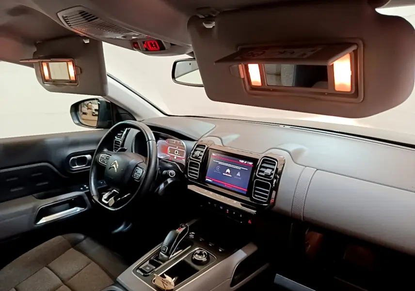 Intérieur du Citroën C5 Aircross noir, vue côté conducteur, tableau de bord avec écran tactile et volant cuir multifonctions.