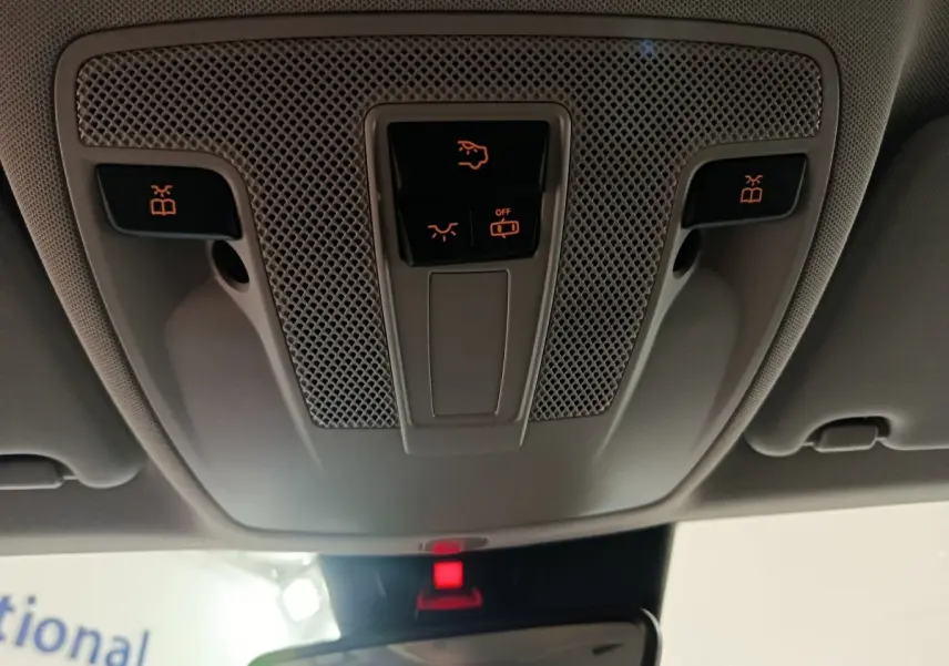 Vue en gros plan du plafonnier gris clair du Mercedes GLA 200 d Business Executive avec commandes d'éclairage et alarme activée.