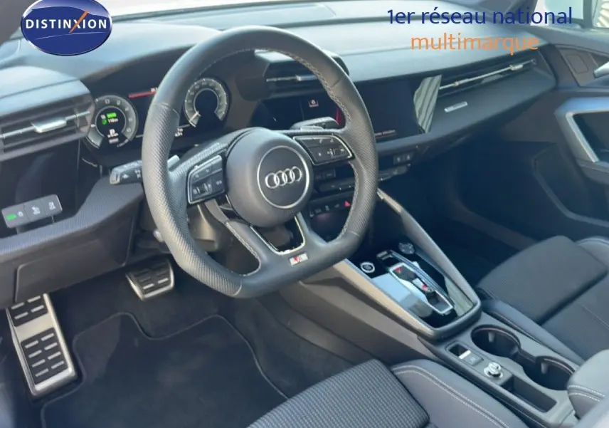 Vue intérieure côté conducteur de l'Audi A3 Sportback 40 TFSIe S-Line 2025 avec volant cuir et tableau de bord moderne.