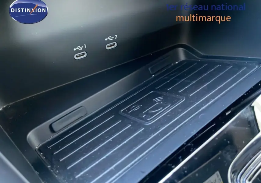 Gros plan sur la console centrale d’une Audi A3 Sportback blanche 2025, montrant le chargeur sans fil et ports USB.