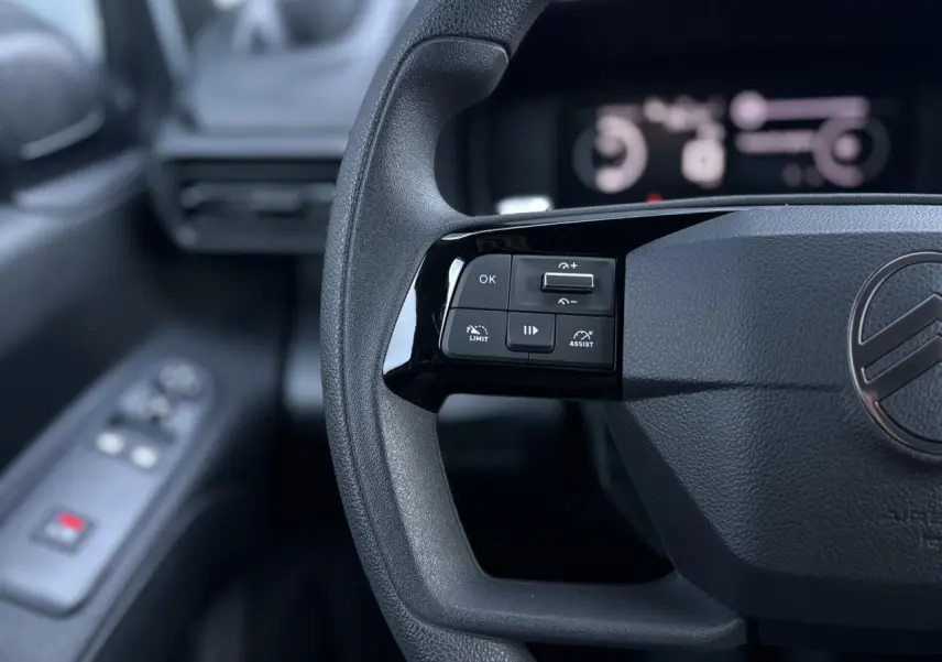 Gros plan sur le volant multifonctions du Citroën Berlingo 2025, avec commandes de régulateur et limiteur de vitesse.