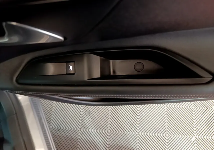 Gros plan sur la poignée intérieure noire de la porte côté gauche du Peugeot 5008 gris clair 2020.