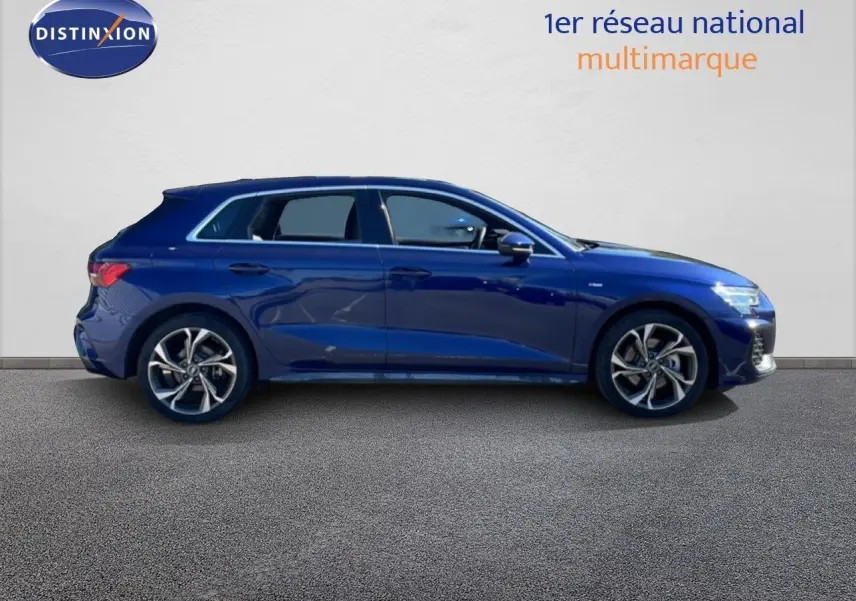 Vue de profil côté gauche d'une Audi A3 Sportback 40 TFSIe hybride rechargeable en bleu Navarre métallisé avec jantes alliage.