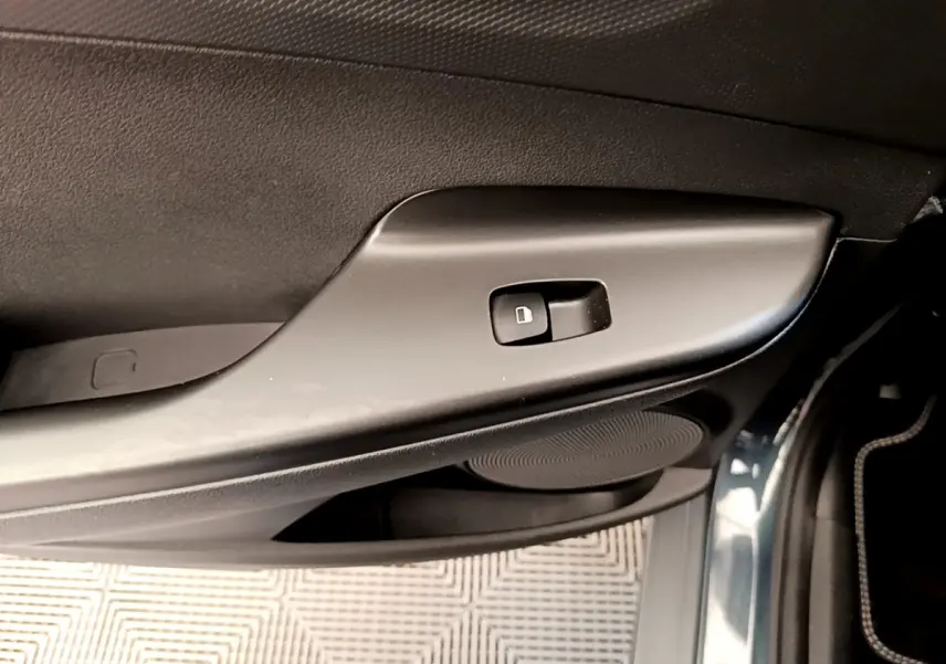 Détail de la commande de verrouillage sur la porte avant droite du Hyundai Kona électrique bleu 2023.