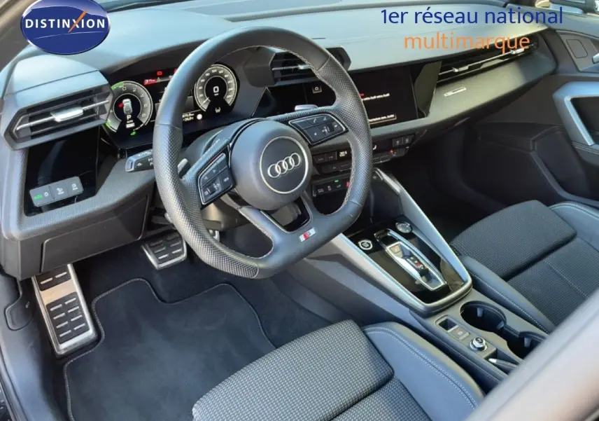 Vue intérieure de l'Audi A3 Sportback 2025, tableau de bord et volant S-Line en cuir noir avec finitions modernes.