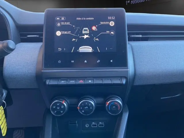 Vue rapprochée de la console centrale de la Renault Clio V PH2 TCE 90 Evolution avec écran tactile et commandes de climatisation.