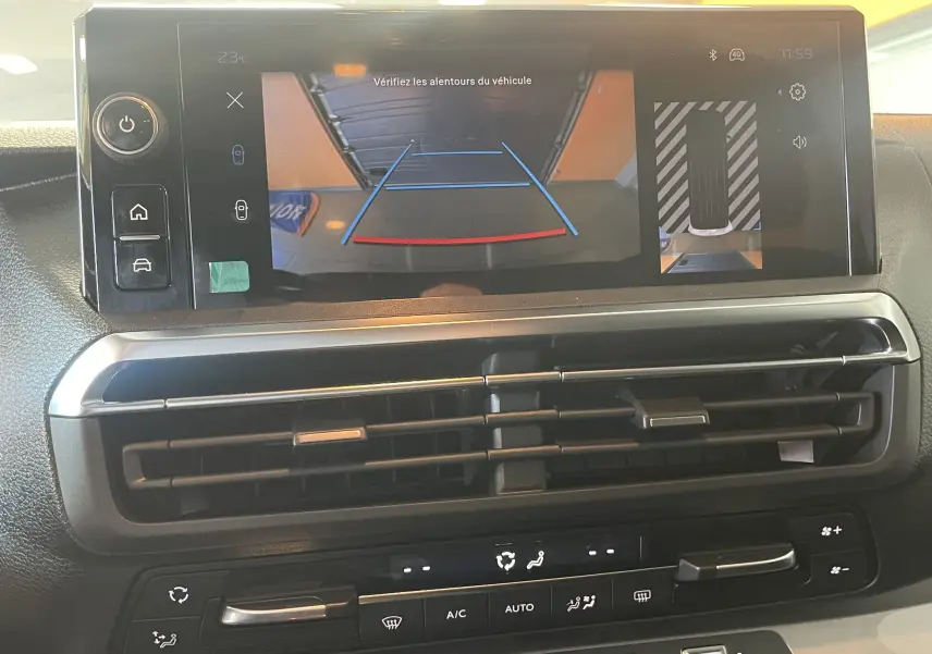 Écran central du Peugeot Traveller 2026 montrant la caméra de recul et les commandes de climatisation intégrées sous la ventilation.