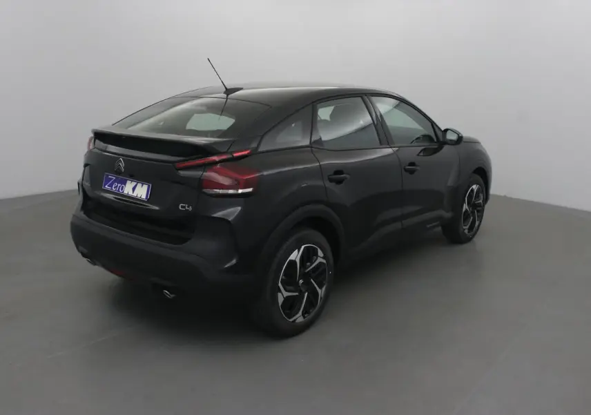 Vue 3/4 arrière droite d'une Citroën C4 noire 2022 avec jantes alliage et feux arrière LED distinctifs.