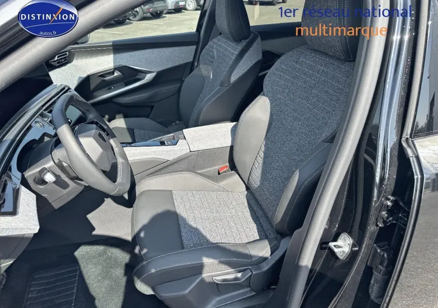 Vue intérieure côté conducteur du Peugeot 3008 noir perla nera, sièges tissu et cuir avec accoudoir central.