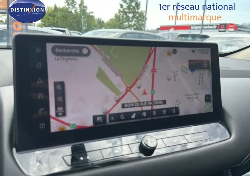 Écran tactile central du Nissan Qashqai 2023 blanc nacré, affichant la navigation GPS avec carte détaillée.