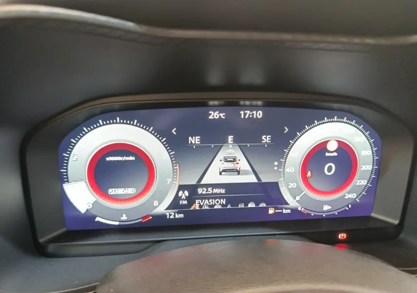 Affichage numérique du combiné d'instruments du Nissan Juke bleu, vue frontale du tableau de bord avec navigation et compte-tours.