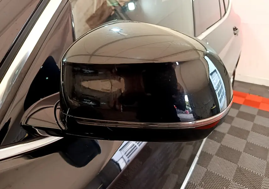 Rétroviseur côté gauche noir brillant d'un BMW X3 xDrive20d 2019, avec clignotant intégré visible en bas.