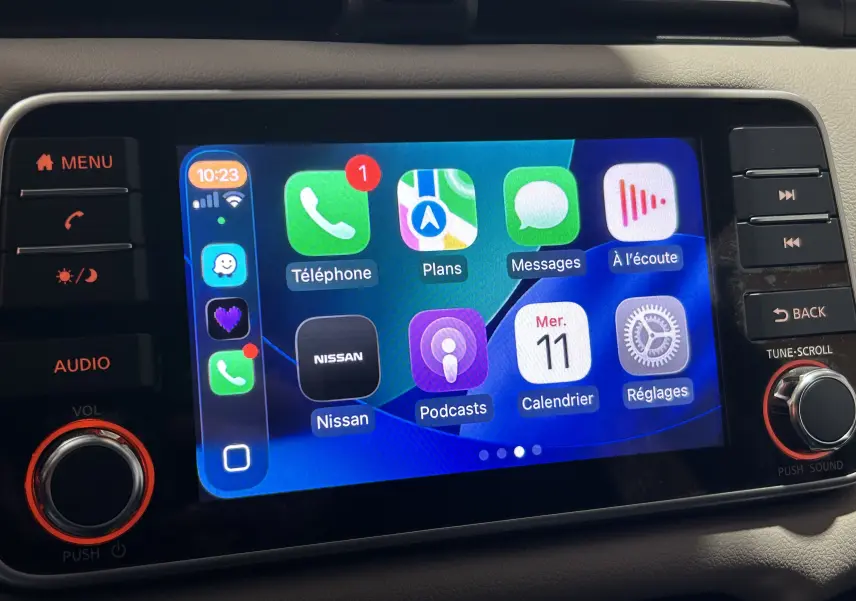 Écran tactile central de la Nissan Micra blanc 2021 affichant l'interface Apple CarPlay avec plusieurs applications.