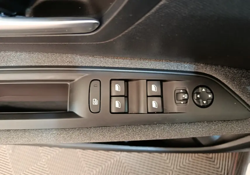 Vue rapprochée des commandes de lève-vitres et réglage des rétroviseurs côté conducteur du Peugeot 3008 gris foncé 2022.