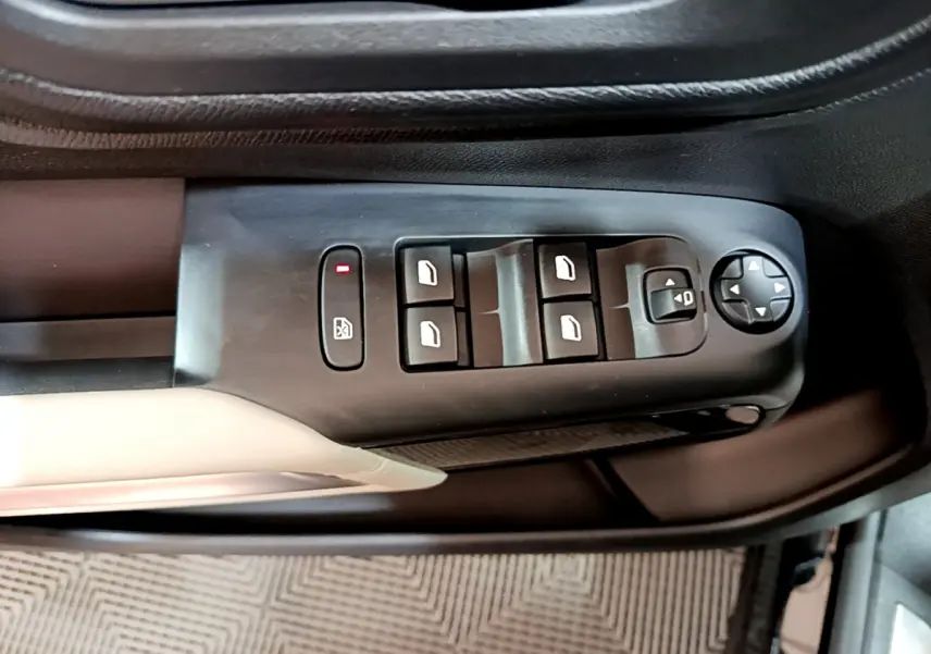 Gros plan sur les commandes des vitres et rétroviseurs côté gauche d'une Citroën C5 Aircross Hybrid noire.