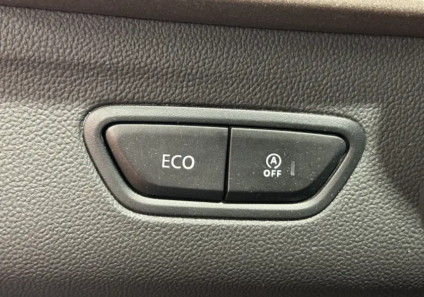 Gros plan sur les boutons ECO et désactivation du start-stop dans l'habitacle du Renault Kadjar gris 2015.