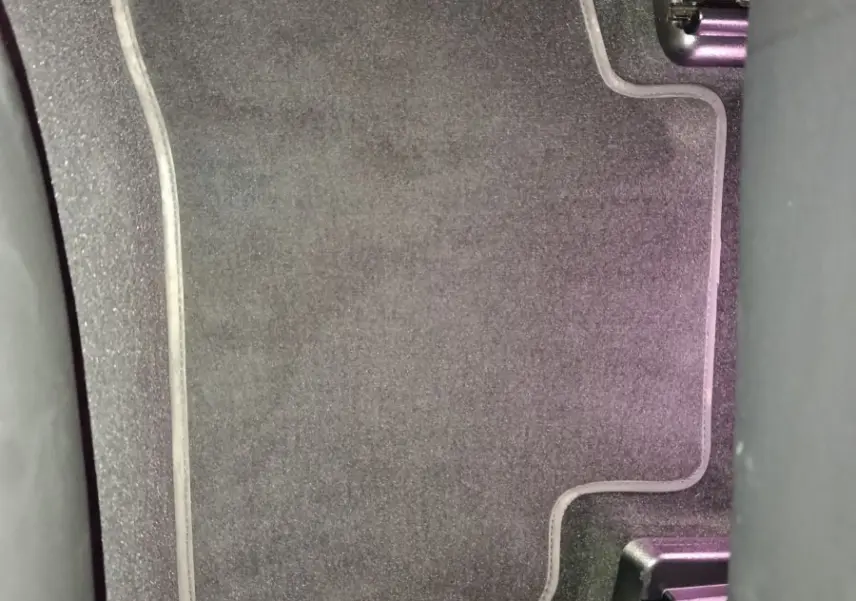 Vue rapprochée du tapis de sol noir à bordure grise dans l'habitacle d'un Mercedes GLC 300 e Business Line 2020.